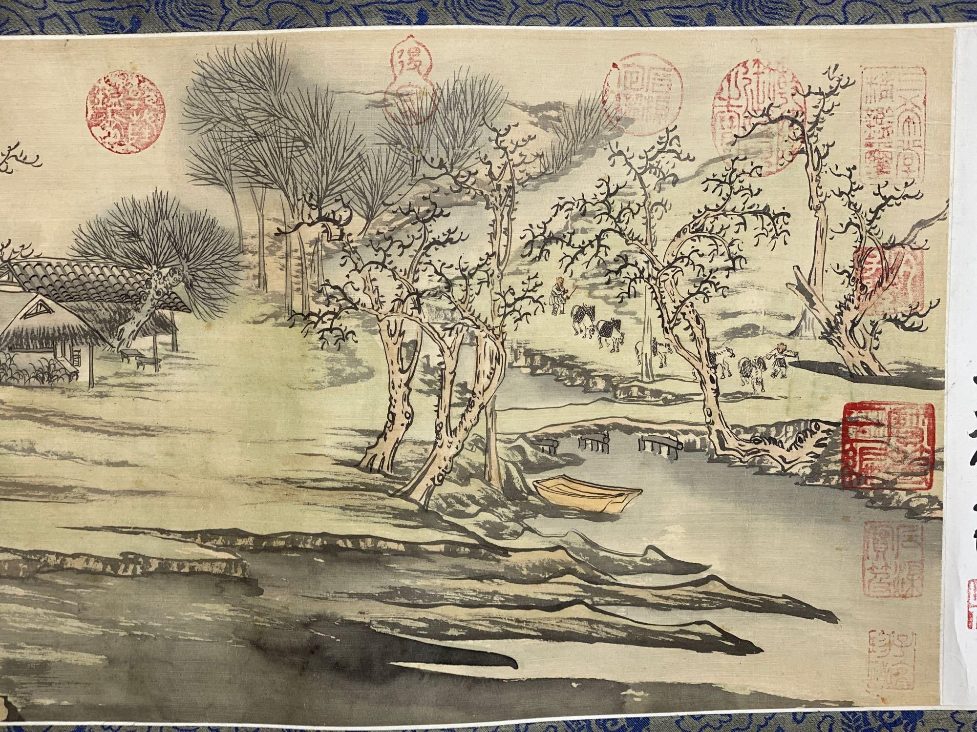 A Chinese landscape painting on silk handscroll with script, approximately 520 x 22cm